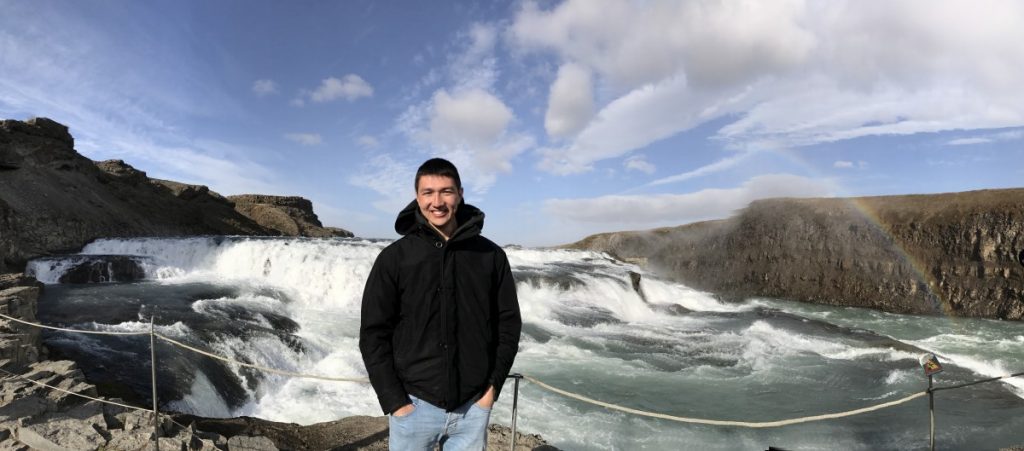 Study abroad student stands in front of Iceland glacier