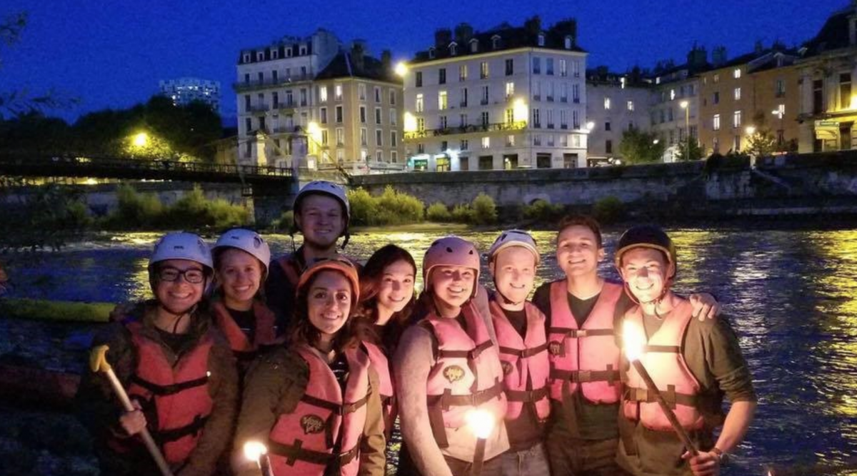 study abroad students at night by isere river grenoble france