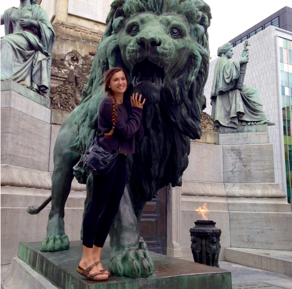 Volunteer Michelle Stepan stands in front of lion statue in Argentina