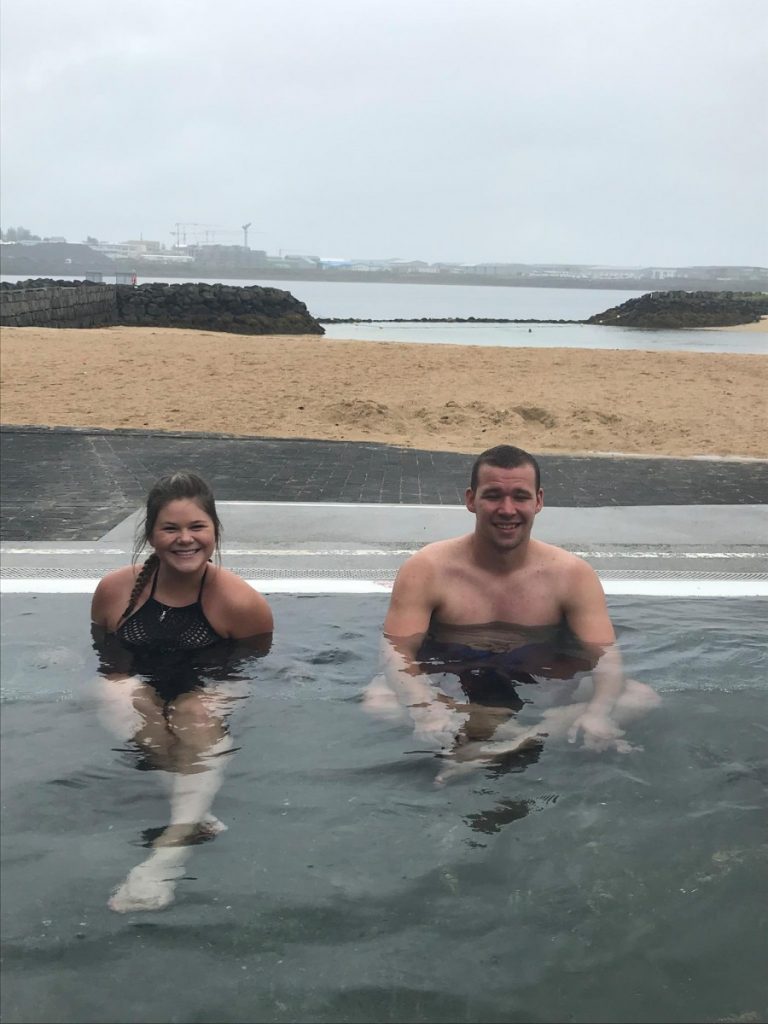 Study abroad students soak in a hot spring in Reykjavik