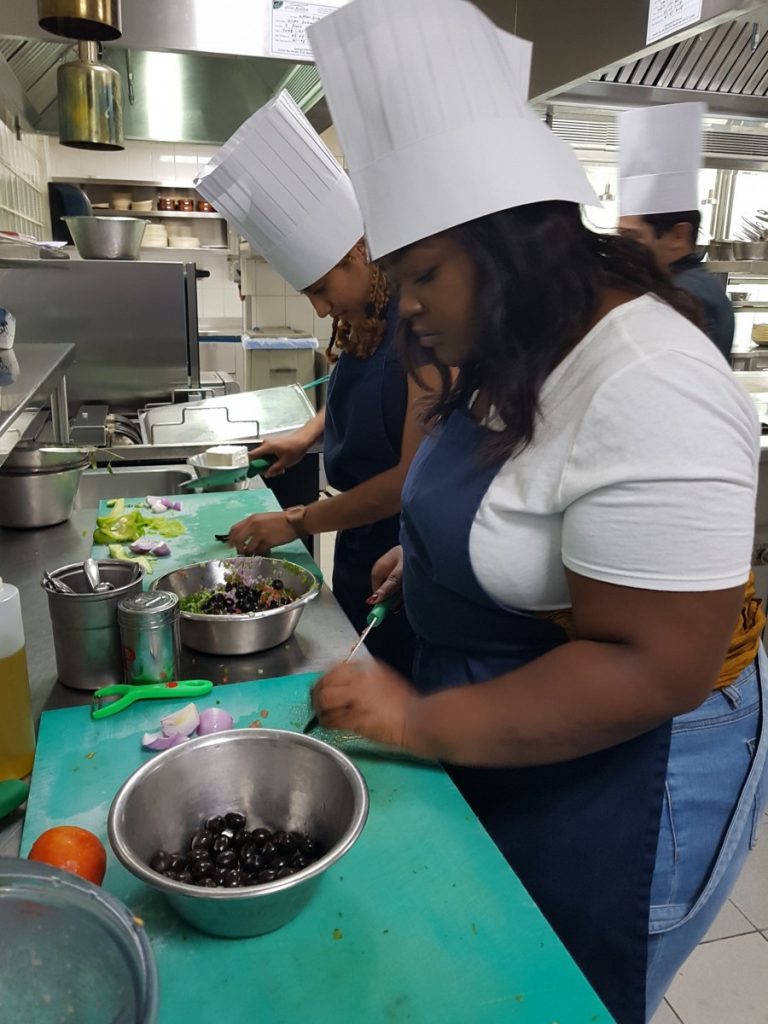 Study abroad student learning to make Arabic food in Sharjah cooking class