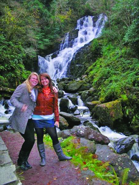 Study abroad students stand in front of waterfall in Cork, Ireland