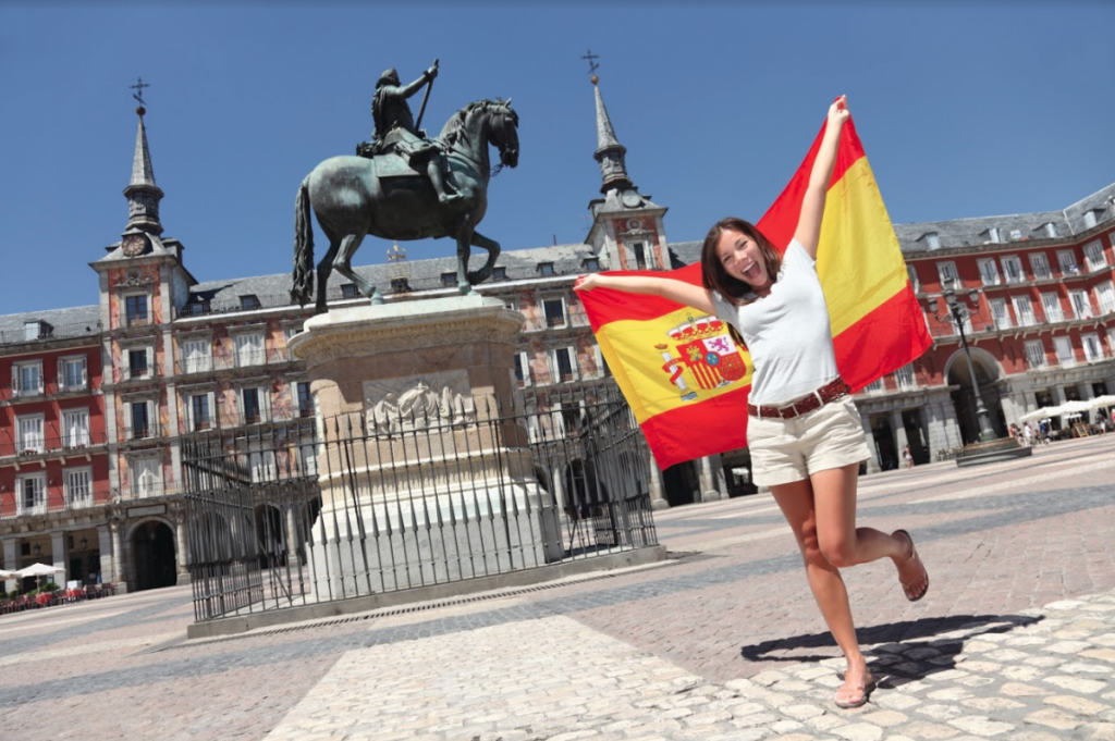 Study abroad student holding Spain flag in Madrid