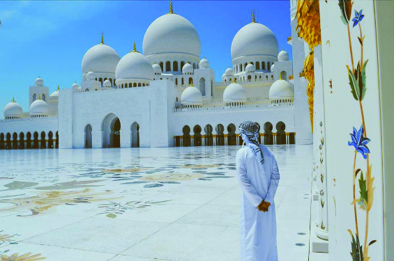 Study abroad student stands in front of a mosque in Sharjah, UAE
