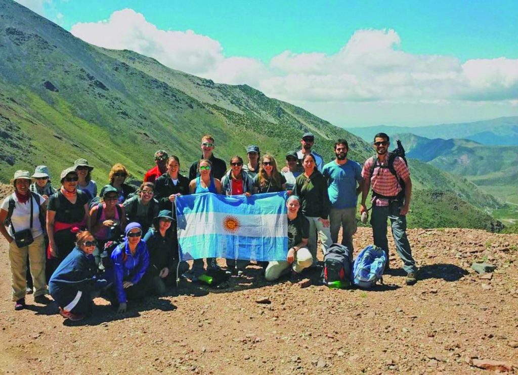 API Buenos Aires students hold Argentine flag on mountain