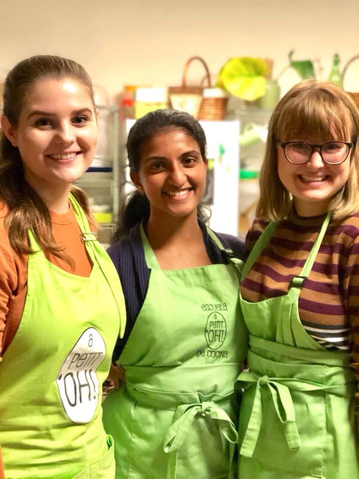 API students pose in their green aprons for a Madrid cooking class
