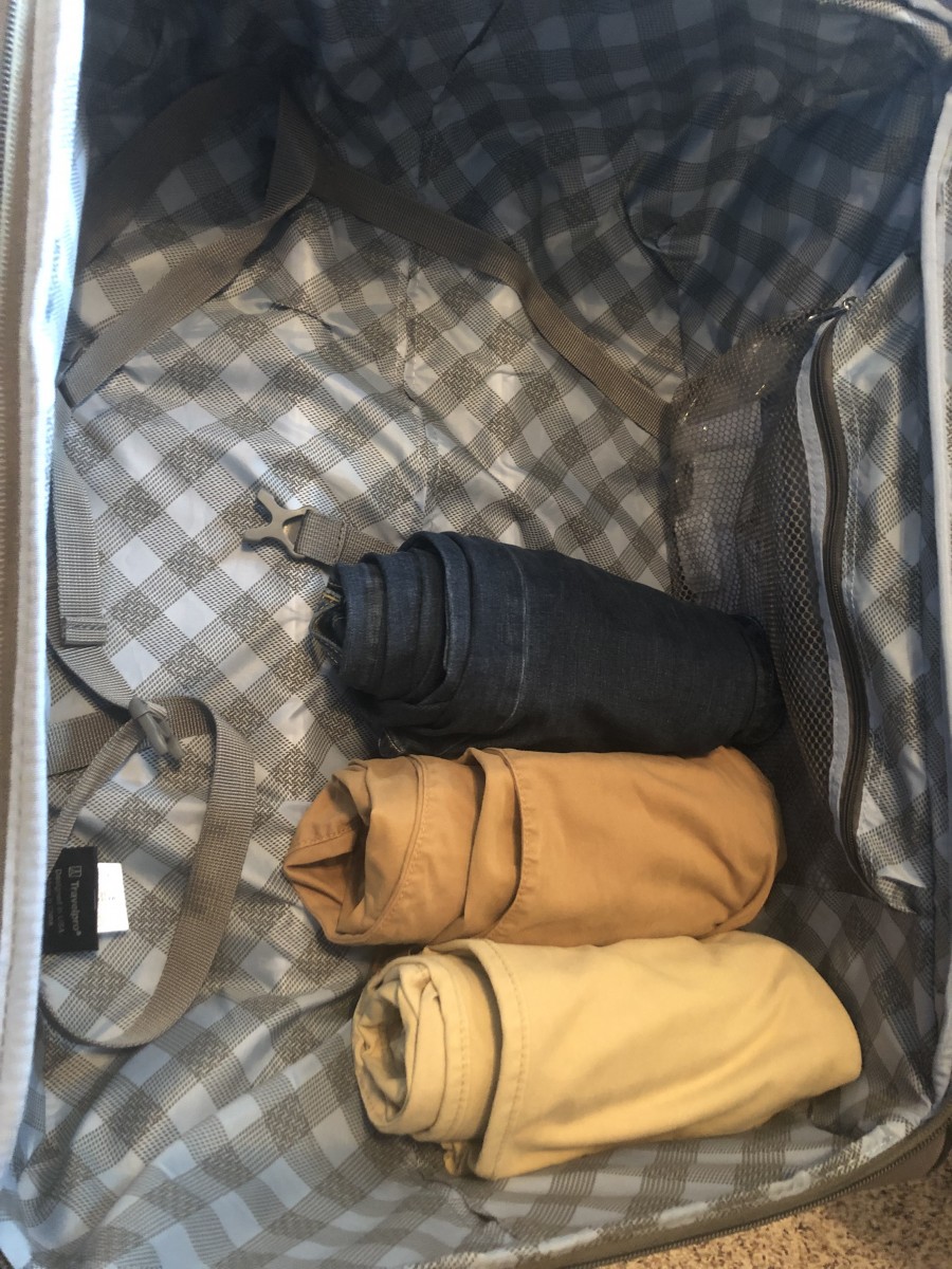 how to roll clothing to pack suitcase