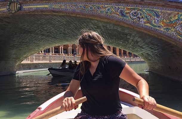 Student rowing boat through Venice canals