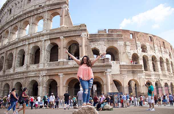 API student poses in front of Roman Colosseum