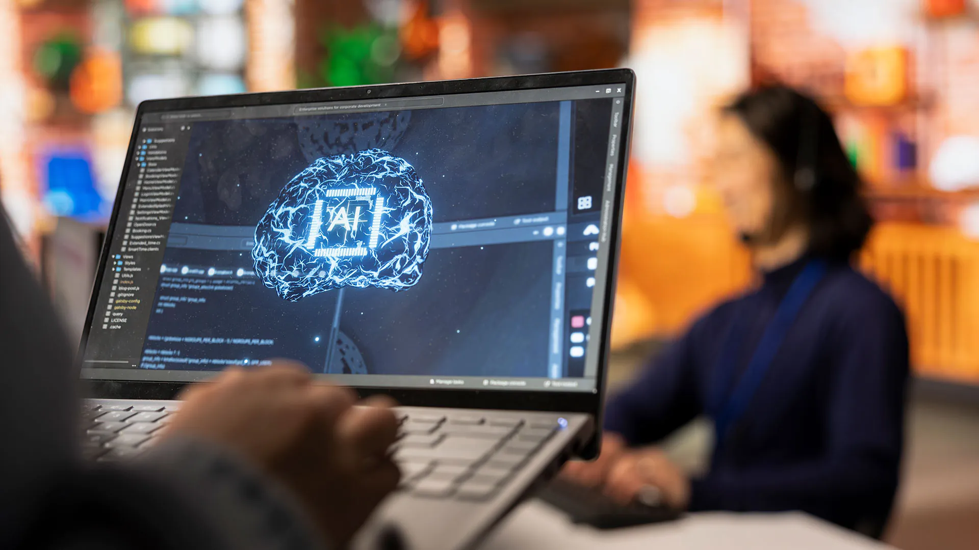 Man using laptop with AI graphic on screen