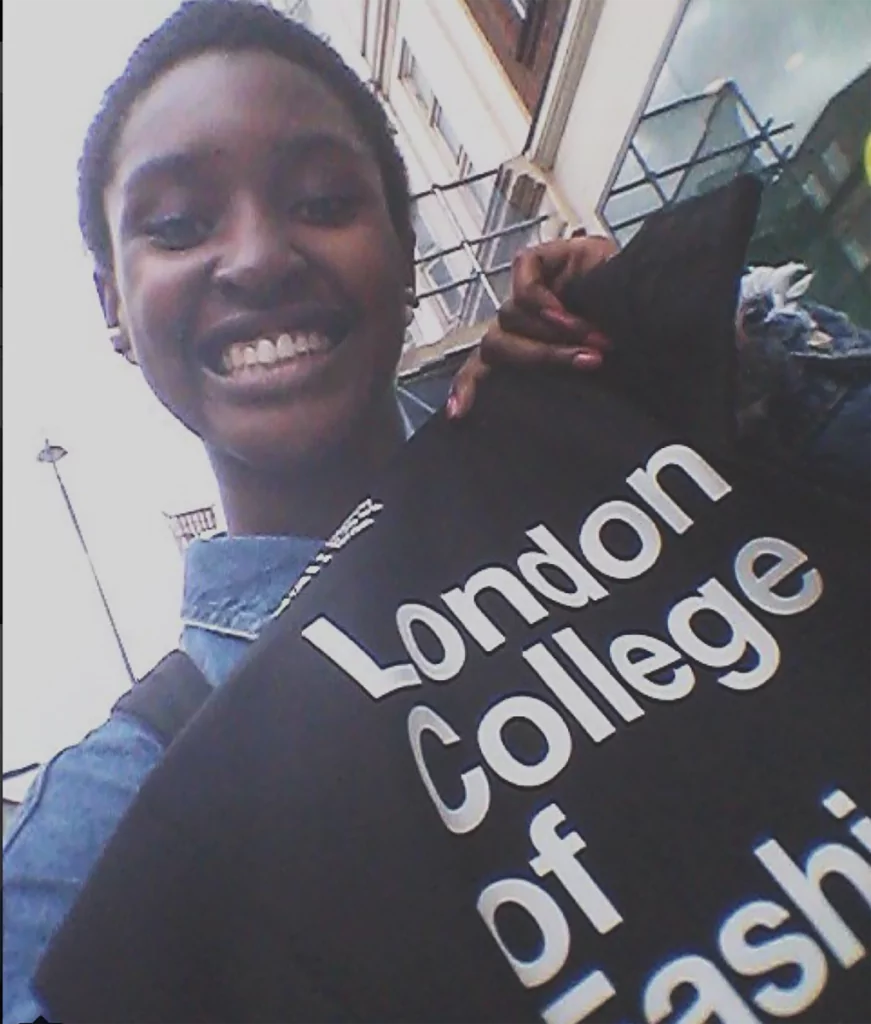 Study abroad student holds flag for London College of Fashion