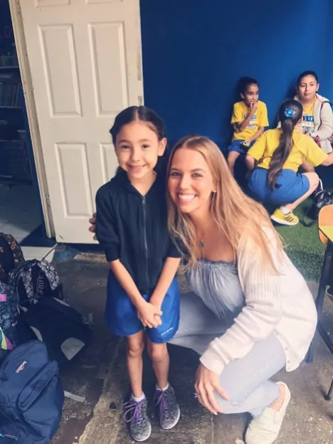 API Teacher in Costa Rica smiles with one student
