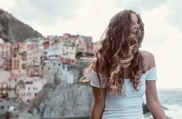 Student in coastal Italy on a windy day