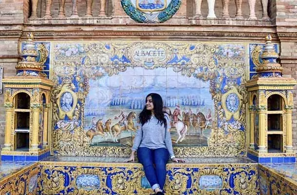 Student sitting with mural wall behind