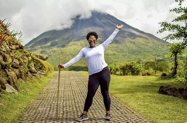 Student poses with Volcan Arenal in Costa Rica